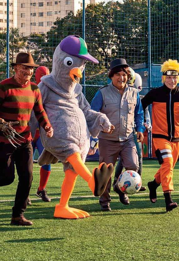 O mascote pombo conduzindo a bola
